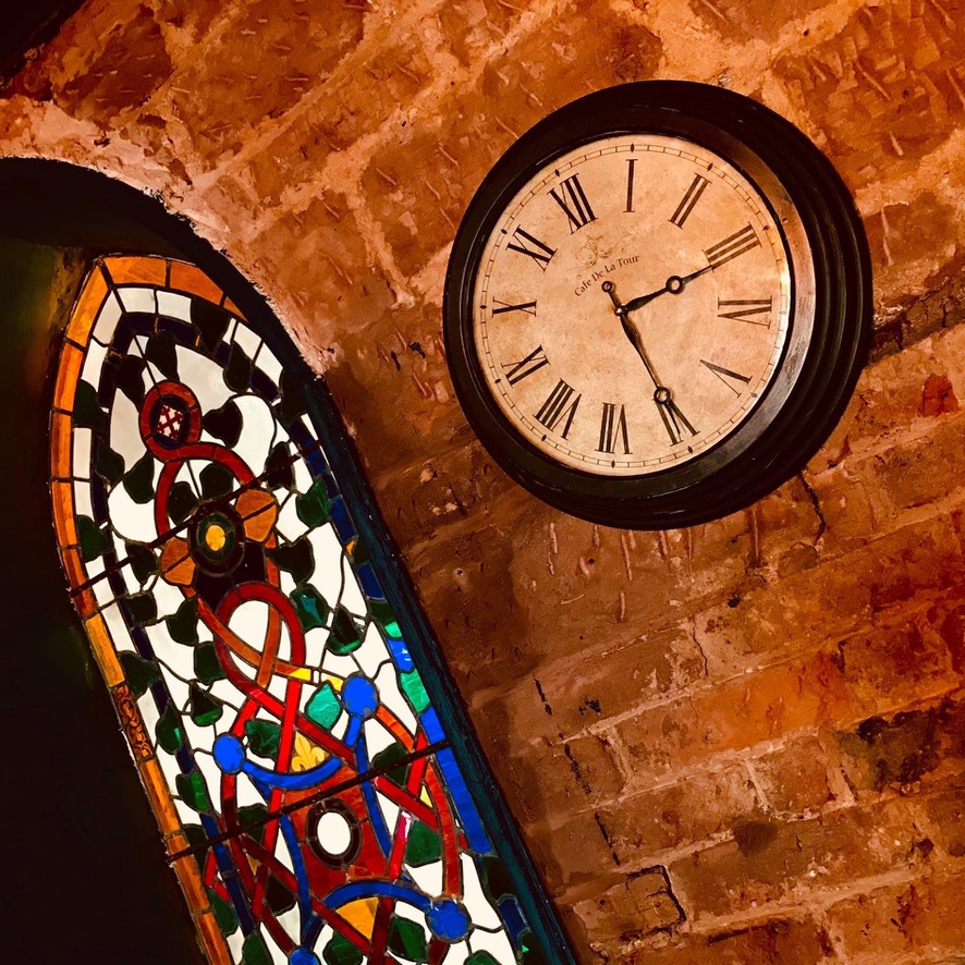 Stained glass and clock detail inside the main bar