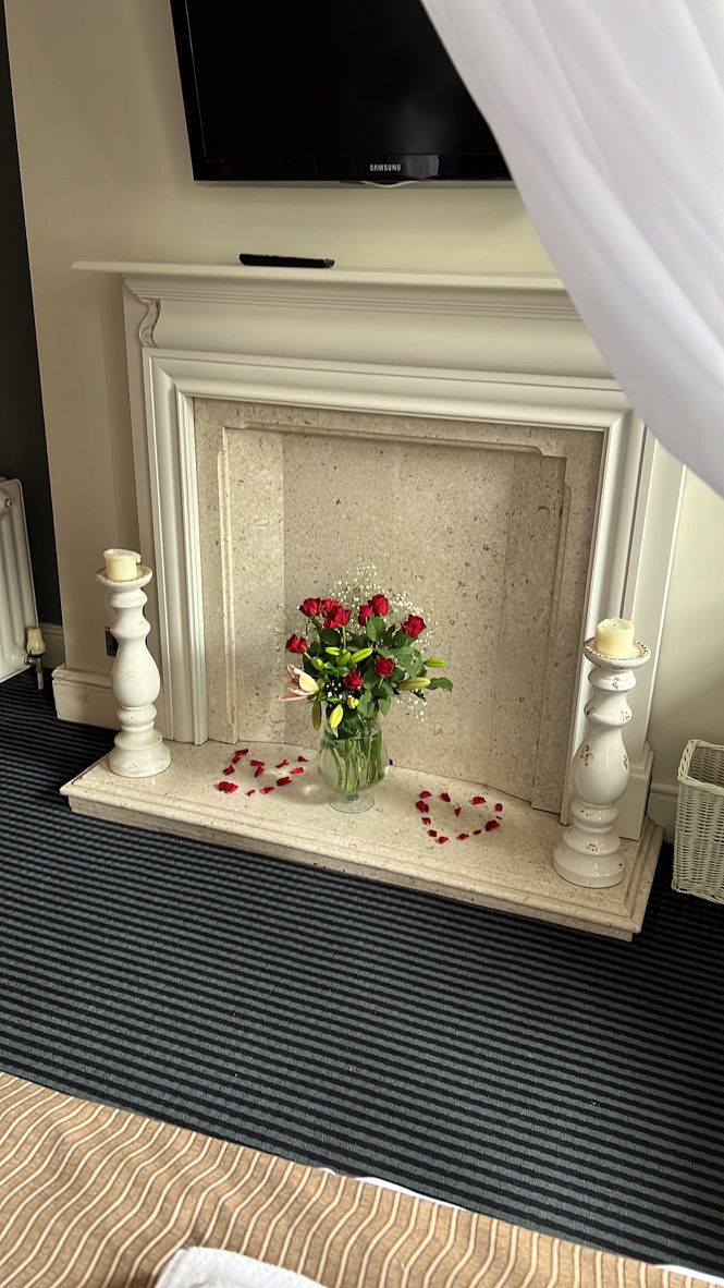 Honeymoon suite styling with roses and candles at The Silk House
